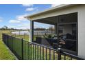 Screened patio overlooking a lake with outdoor furniture at 2709 Greenlands St, St Cloud, FL 34772