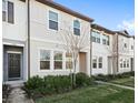 Two-story townhome with dark gray door and neutral colored siding at 3092 Water Sprite St, Orlando, FL 32808