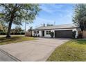 Charming ranch-style home with a spacious driveway and well-manicured lawn at 3118 Clemwood St, Orlando, FL 32803