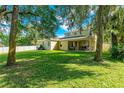 Spacious backyard with a patio and lush greenery at 3442 Starbird Dr, Ocoee, FL 34761