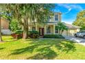 House exterior showcasing a two-story home with lush landscaping at 3442 Starbird Dr, Ocoee, FL 34761