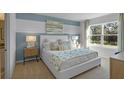 Bright bedroom with a white bed and blue accent wall at 4245 Singing Mockingbird Blvd, Bartow, FL 33830