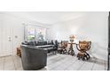 Living room with gray couches, dark wood chairs, and tiled floors at 4401 Santee St, Orlando, FL 32804