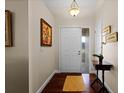 Bright entryway with hardwood floors and wall art at 4818 Breezy Palms Ct, Windermere, FL 34786