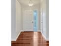 Inviting foyer with wood floors, showcasing a bright entry door and neutral wall color at 4818 Breezy Palms Ct, Windermere, FL 34786