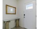 Bright entryway with a glass-top console table and a gold framed mirror at 54 Bella Oaks Dr, Port Orange, FL 32129