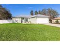 House with attached garage and expansive lawn at 652 Mountain Way Ave, Deltona, FL 32738