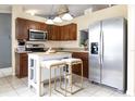 Kitchen boasts an island, stainless steel appliances, and wood cabinets at 652 Mountain Way Ave, Deltona, FL 32738