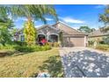 House exterior featuring a landscaped yard and palm tree at 826 Seneca Trl, St Cloud, FL 34772