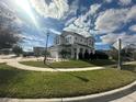 Two-story house with gray exterior, paver driveway, and landscaping at 3020 Cardillino Way, Kissimmee, FL 34741