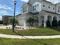 Two-story house with gray exterior, paver driveway, and landscaping at 3020 Cardillino Way, Kissimmee, FL 34741