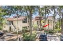 Charming condo exterior with well-maintained landscaping and covered parking at 1000 Winderley Pl # 143, Maitland, FL 32751