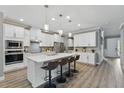 Bright modern kitchen featuring white cabinets, an island with seating, and stainless steel appliances at 10219 Atwater Bay Dr, Winter Garden, FL 34787