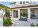 Beautiful front courtyard featuring a fountain and manicured plants leading up to the home's entrance at 10380 Kensington Shore Dr, Orlando, FL 32827