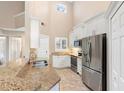 Modern kitchen with stainless steel appliances and granite countertops at 110 Becket Ln, Lake Mary, FL 32746