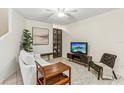 Living room with a sofa, shelving, and a large TV at 1120 Portland Ave # 4, Orlando, FL 32803