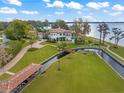 Expansive waterfront property with a luxurious home, boat house, lush lawns, and a private canal at 11900 Lake Butler Blvd, Windermere, FL 34786