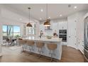 Modern kitchen featuring white cabinets, quartz countertops, and an island at 13415 Laxness St, Orlando, FL 32827