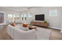 Bright living room with hardwood floors and a neutral color palette at 13415 Laxness St, Orlando, FL 32827
