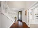 Bright entryway with hardwood floors, elegant staircase, and high ceilings at 1415 Brumley Rd, Chuluota, FL 32766