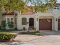 Charming facade features a secure gated entry, arched windows, and an attached two-car garage at 1446 Berkshire Ave, Winter Park, FL 32789