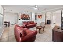 Open living room with leather sofas and access to kitchen at 15239 Firelight Dr, Winter Garden, FL 34787