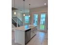 Modern kitchen with white cabinets, stainless steel appliances, and an island at 1545 Heritage Pl, Oviedo, FL 32765