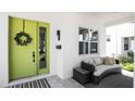 Inviting front porch with a lime-green door and wicker seating at 2315 Depauw Ave, Orlando, FL 32804
