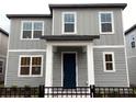 Two-story house, gray siding, and a blue front door at 2425 Zuni Rd, St Cloud, FL 34771