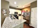 Galley kitchen with granite countertops and stainless steel appliances at 3208 Oyster Ln, Kissimmee, FL 34747