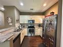 Galley kitchen with granite countertops and stainless steel appliances at 3208 Oyster Ln, Kissimmee, FL 34747