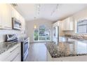 Modern kitchen with stainless steel appliances and granite countertops at 3667 Kingswood Ct, Clermont, FL 34711
