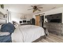 Spacious main bedroom with large TV, dresser, and sliding barn door at 459 Abeno Ave, Deltona, FL 32725