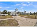 Front view of house showcasing the yard, driveway, and neighborhood at 459 Abeno Ave, Deltona, FL 32725