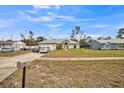 House exterior with a neat lawn and a sidewalk leading to the entrance at 459 Abeno Ave, Deltona, FL 32725