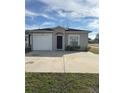 Newly built home showcasing a garage and well maintained lawn at 4660 Carter St, Orlando, FL 32811