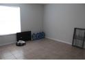 Spacious bedroom with tile flooring, large window, and neutral walls at 5271 Images Cir # 108, Kissimmee, FL 34746