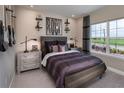 A bedroom with a bed, guitar wall mounts, and a large window at 5296 Bowspirit Way, St Cloud, FL 34769