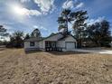 Newly built home with white exterior, black accents, and a two-car garage at 702 Marion Oaks Manor, Ocala, FL 34473