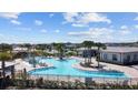 Large community pool with surrounding lounge chairs at 7149 Dilly Lake Ave, Groveland, FL 34736