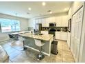 Modern kitchen with white cabinets, granite counters, and island at 840 Las Fuentes Dr, Kissimmee, FL 34746