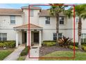 Inviting townhome featuring stucco walls, a tile roof, well-manicured lawn and mature palm trees at 9043 Dogleg Dr, Davenport, FL 33896