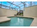 Enclosed private pool area with lounge chairs and a screened enclosure at 9043 Dogleg Dr, Davenport, FL 33896