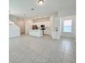 Open concept kitchen with white cabinets, island, and stainless steel appliances at 10432 Austrina Oak Loop, Winter Garden, FL 34787