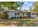 Newly renovated gray house with yellow door and green lawn at 1098 S Oleander St, Longwood, FL 32750