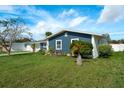 Side view of a charming ranch home with a well-maintained lawn at 1203 Marlowe Ave, Orlando, FL 32809