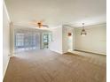 Open concept living and dining area with neutral color palette at 1214 Romani Ave # 10240, Davenport, FL 33896
