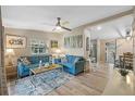 Living room with light blue sofas, coffee table, and wood-look floors at 228 Westwood Dr, Leesburg, FL 34748