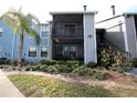 Condo building exterior with screened balcony and landscaping at 3700 Idlebrook Cir # 208, Casselberry, FL 32707