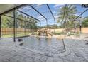 Screened pool area with a waterfall feature and a spacious patio at 5210 Sailwind Cir, Orlando, FL 32810